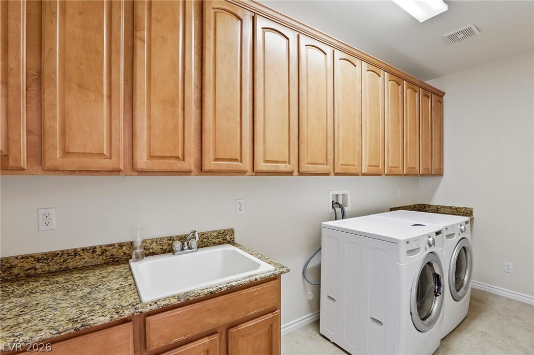 Laundry room with sink, folding counter, and storage